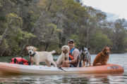 David Blank kayaking with his dogs